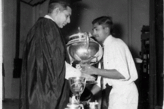 M.H.M. Ameen receiving the Queens Cup from the Principal, A.M.A. Azeez,     at the Assembly of Zahira College in 1957.